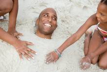 Kids playing with Dad for Father's Day on Pensacola Beach